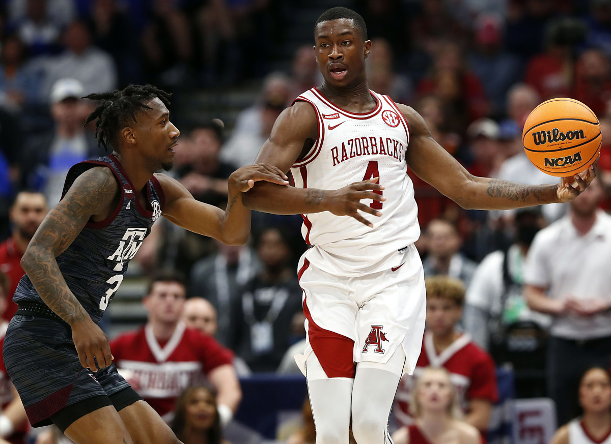 Arkansas guard Davonte Davis loses control of the ball while working against Texas A&M guard Quenton Jackson.